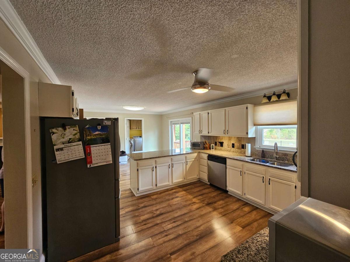 2001 Rutland Road, Unit 1 Tifton, GA 31793 - Photo 36 of 51 a kitchen with granite countertop a refrigerator stove top oven and sink