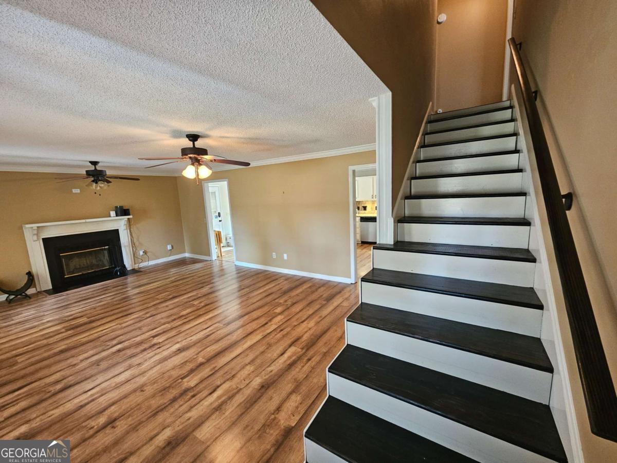 2001 Rutland Road, Unit 1 Tifton, GA 31793 - Photo 38 of 51 a view of a livingroom with wooden floor and stairs