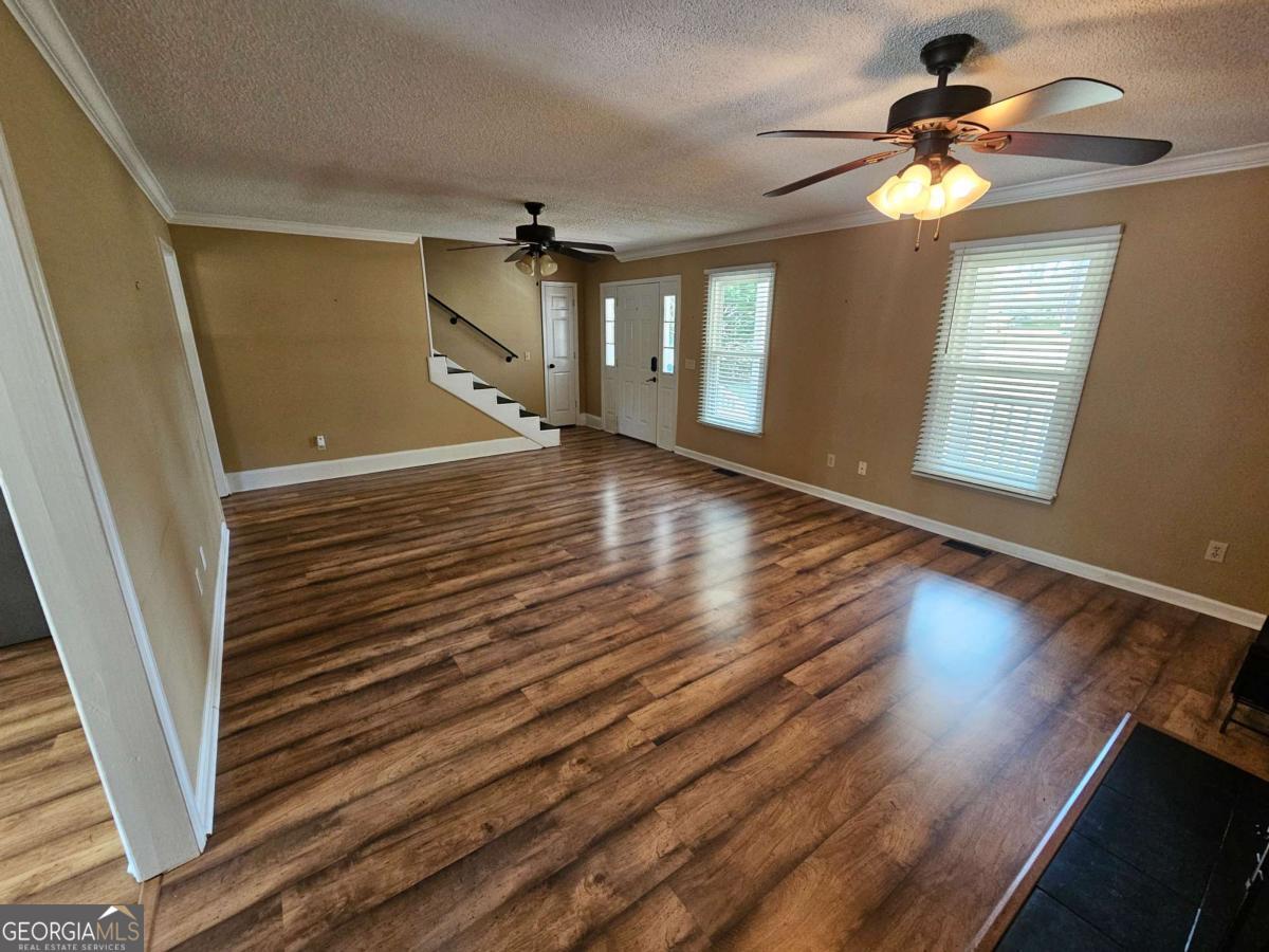 2001 Rutland Road, Unit 1 Tifton, GA 31793 - Photo 39 of 51 a view of empty room with wooden floor and fan