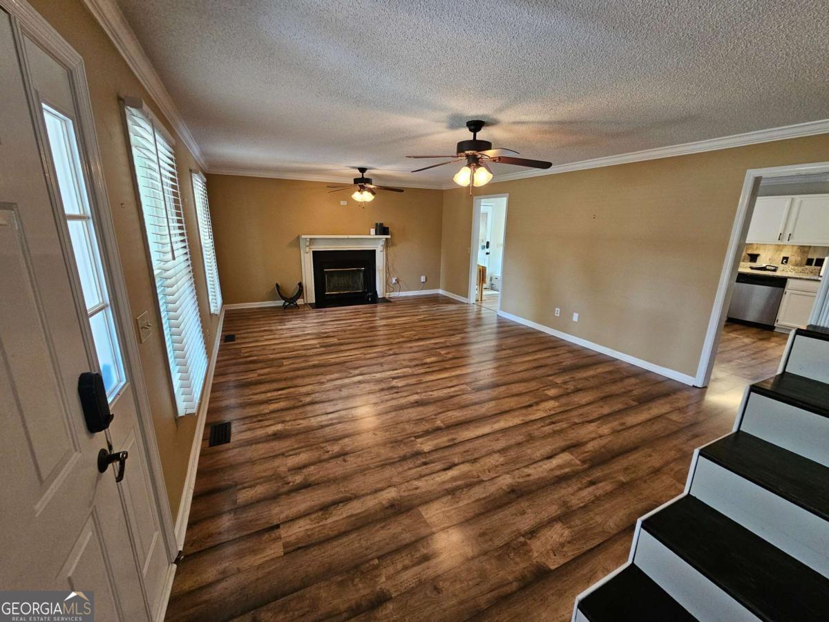 2001 Rutland Road, Unit 1 Tifton, GA 31793 - Photo 40 of 51 a view of a livingroom with wooden floor and fireplace
