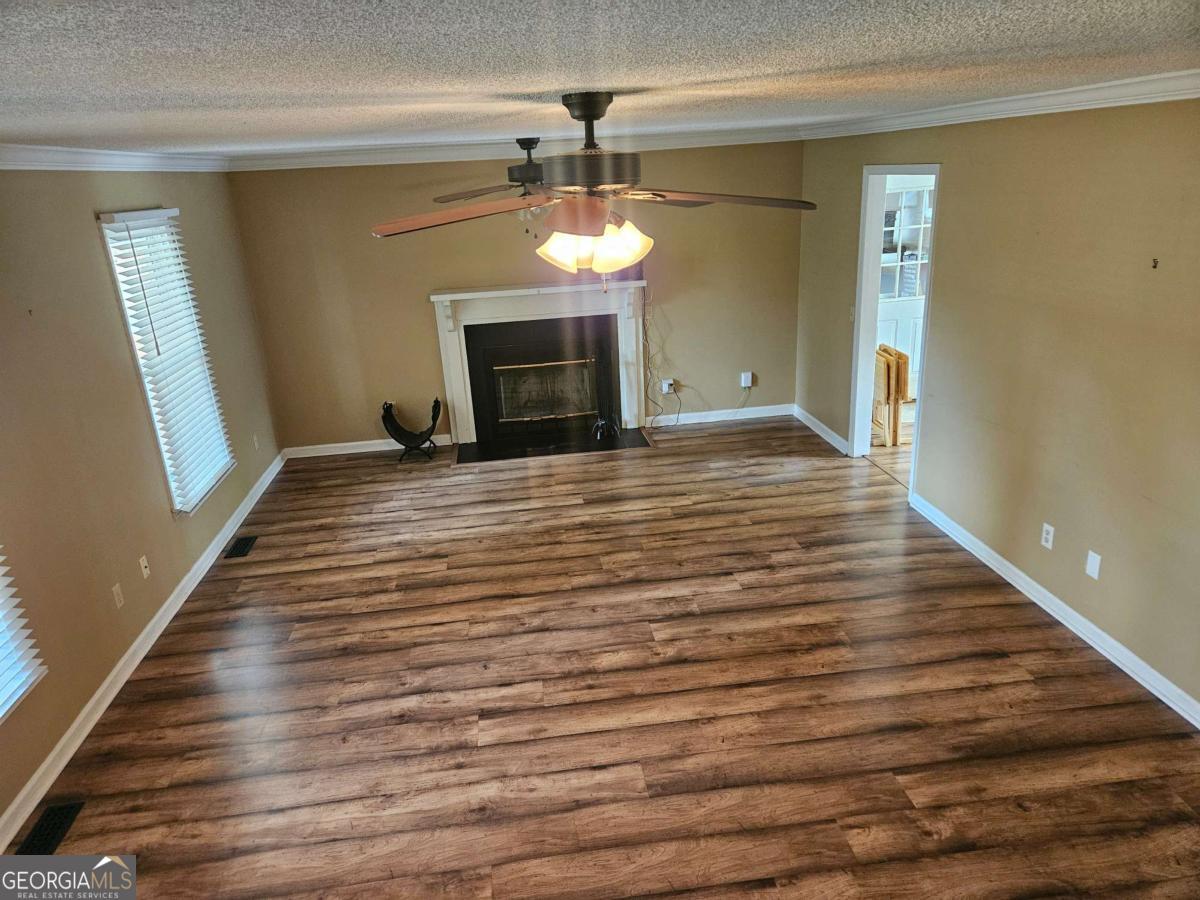 2001 Rutland Road, Unit 1 Tifton, GA 31793 - Photo 41 of 51 a view of an empty room with a fireplace and a window