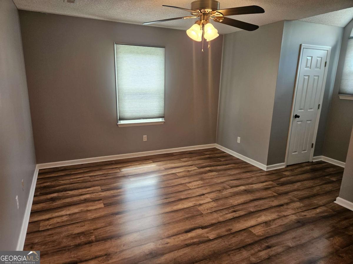 2001 Rutland Road, Unit 1 Tifton, GA 31793 - Photo 49 of 51 a view of an empty room with wooden floor and a window
