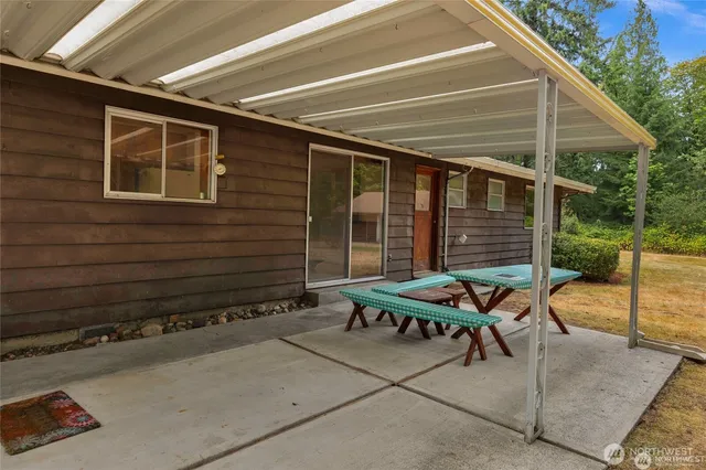 a backyard of a house with outdoor seating