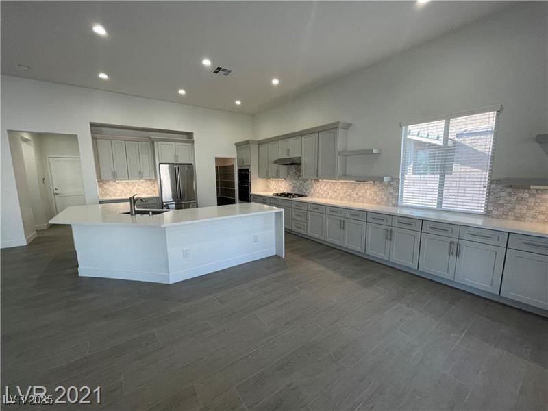 Quartz counters & waterfall island, recessed sink, vaulted ceilings