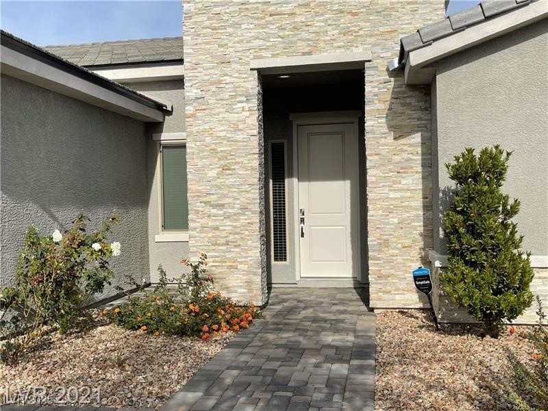 6632 Rashelda Court Las Vegas, NV 89130 - Photo 3 of 27 Front entry with rock facade and covered entry