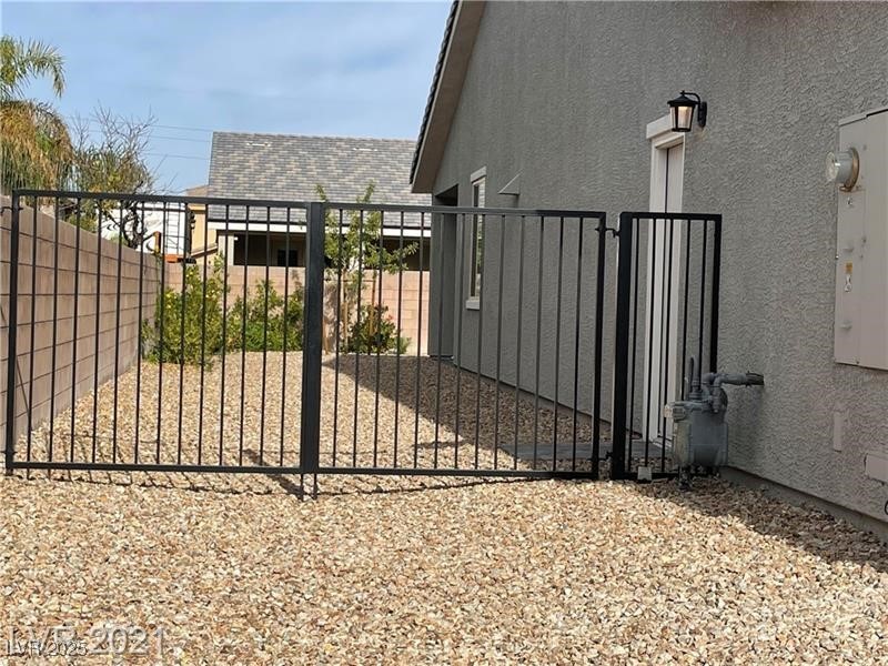 6632 Rashelda Court Las Vegas, NV 89130 - Photo 5 of 27 Side yard with door for garage access