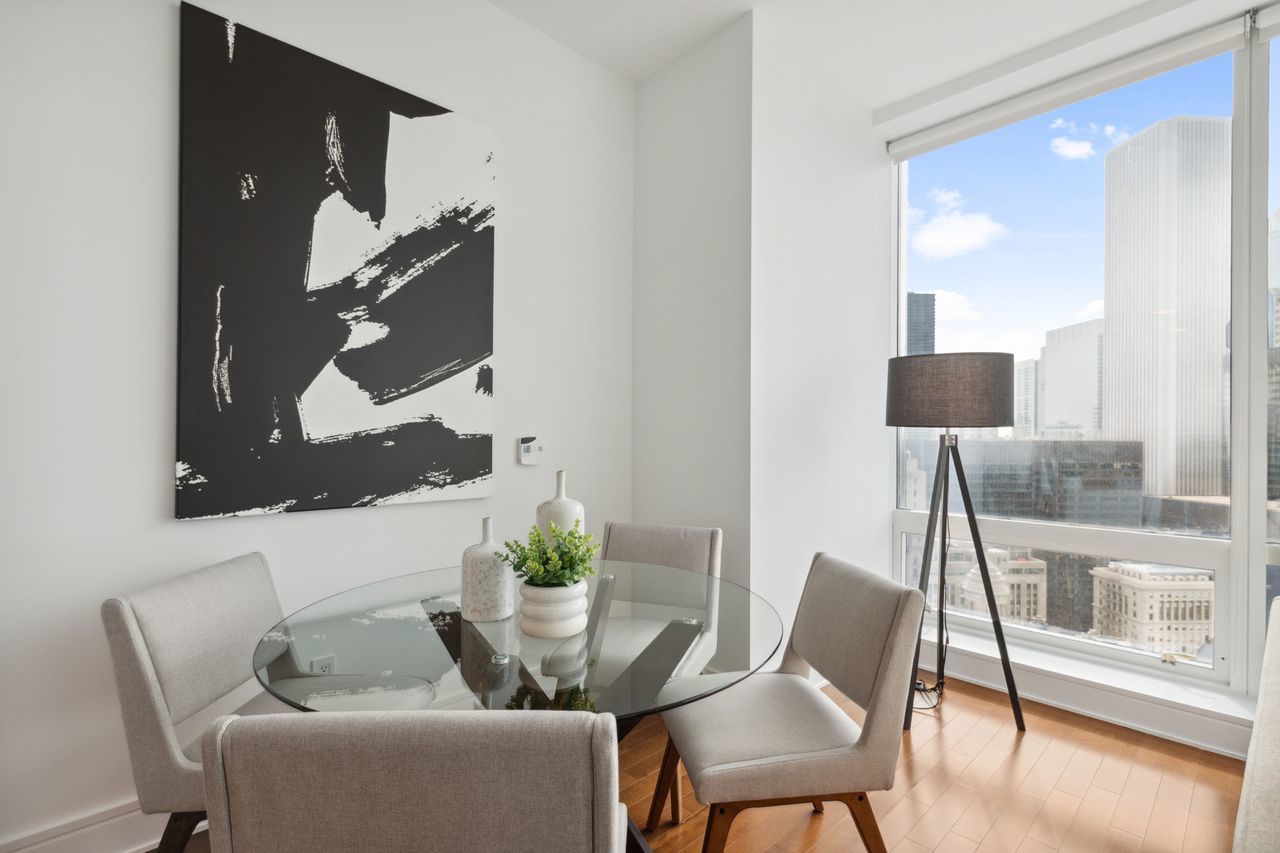 401 North Wabash Avenue, Unit 30I Chicago, IL 60611 - Photo 11 of 49 a dining room with furniture and wooden floor