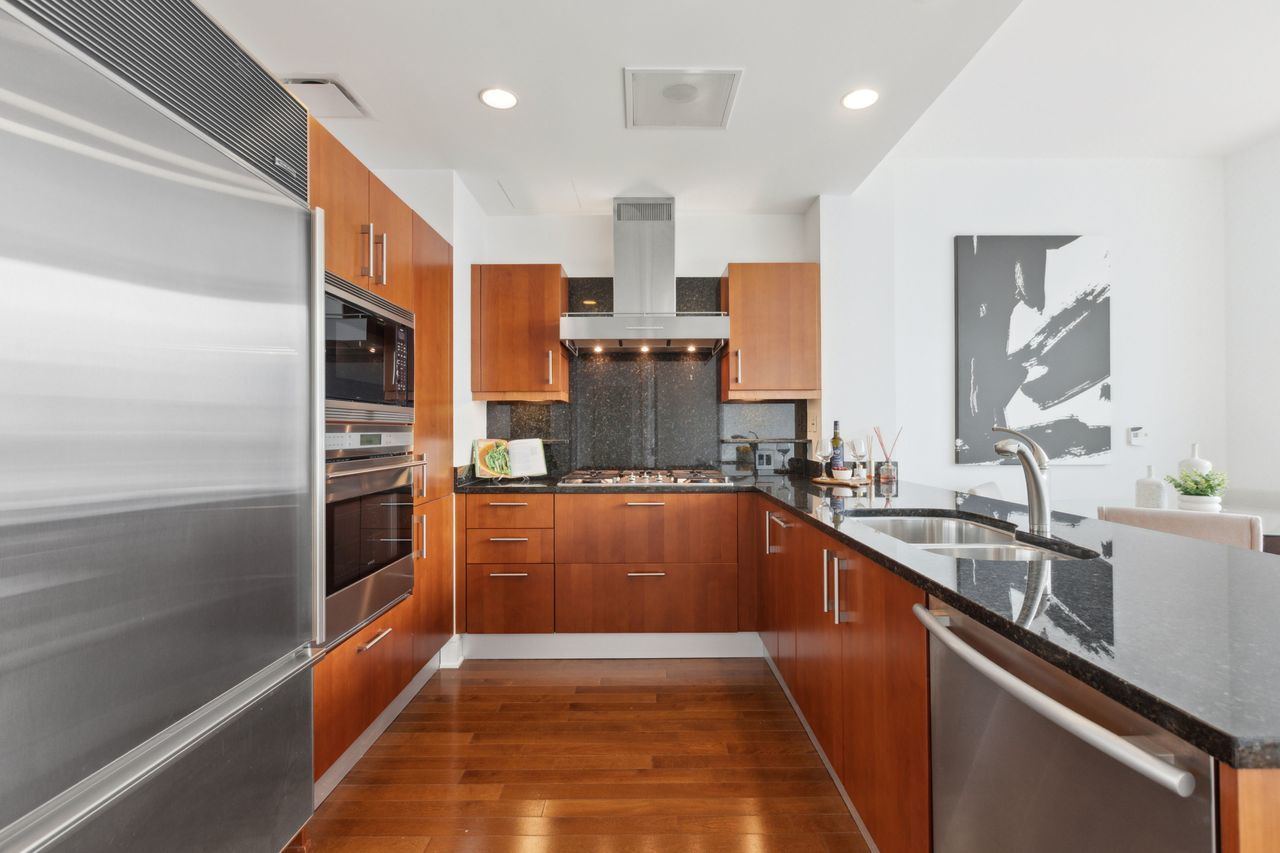 401 North Wabash Avenue, Unit 30I Chicago, IL 60611 - Photo 15 of 49 a kitchen with stainless steel appliances granite countertop a sink and a refrigerator
