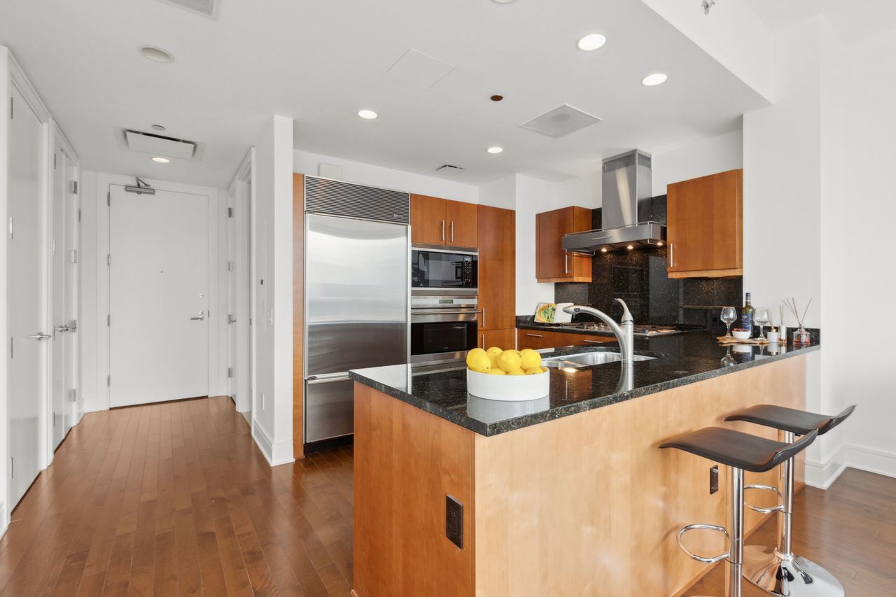 401 North Wabash Avenue, Unit 30I Chicago, IL 60611 - Photo 18 of 49 a kitchen with stainless steel appliances granite countertop a sink and refrigerator