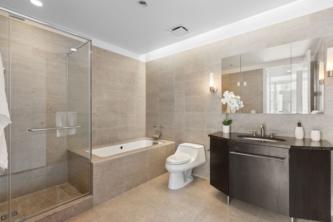 401 North Wabash Avenue, Unit 30I Chicago, IL 60611 - Photo 23 of 49 a bathroom with a double vanity sink toilet and shower