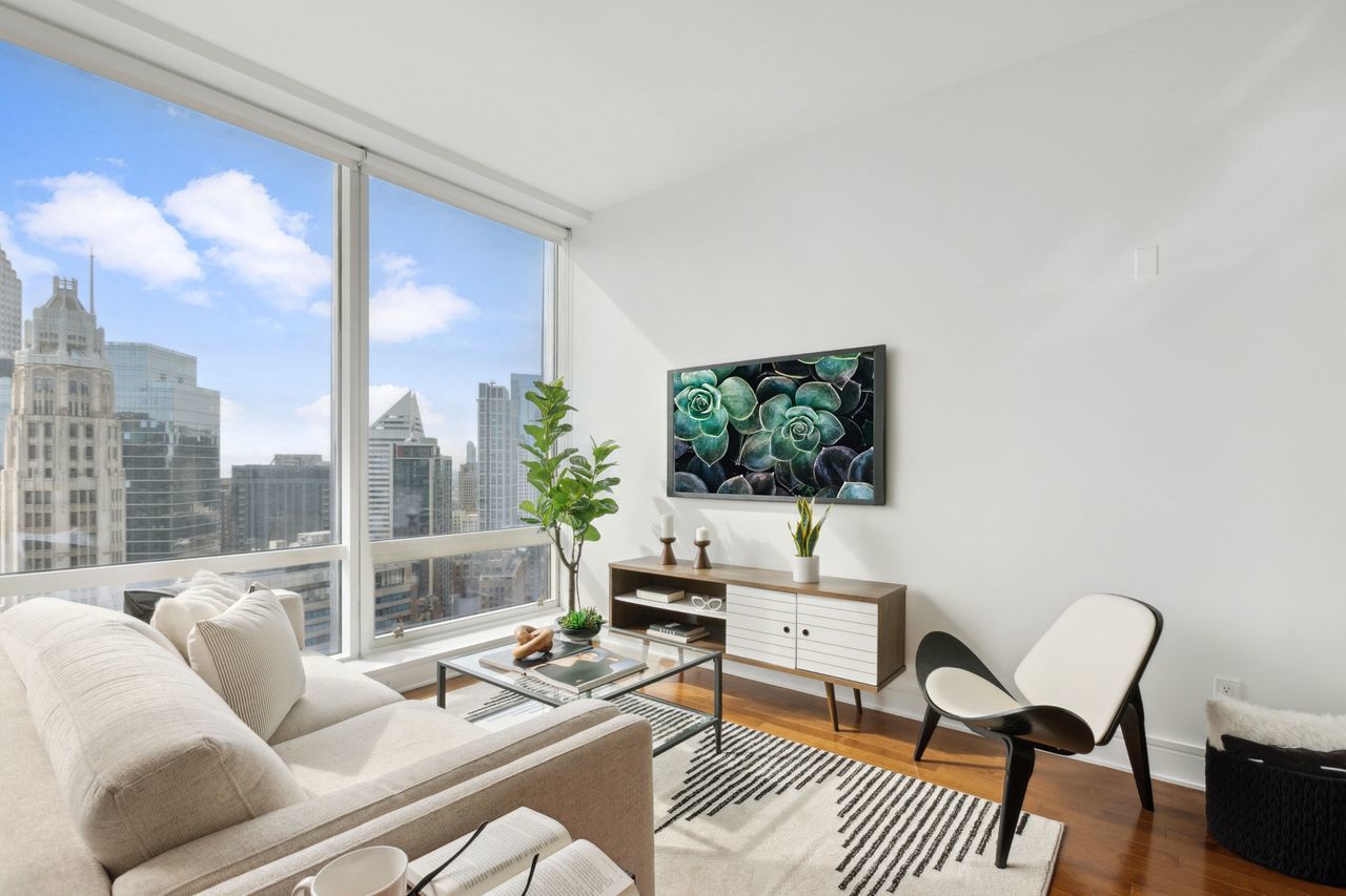 401 North Wabash Avenue, Unit 30I Chicago, IL 60611 - Photo 8 of 49 a living room with furniture a flat screen tv and a floor to ceiling window