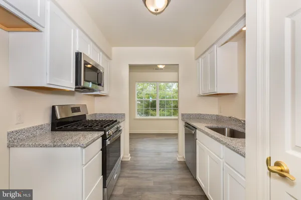 a kitchen that has a sink and a stove