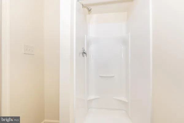 a bathroom with a glass shower door