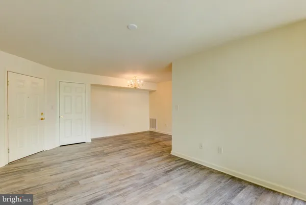 a view of an empty room and wooden floor