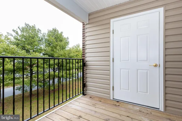 a view of a balcony with wooden floor