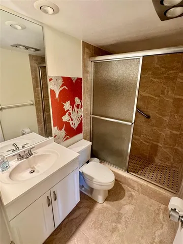 a bathroom with a sink toilet and shower