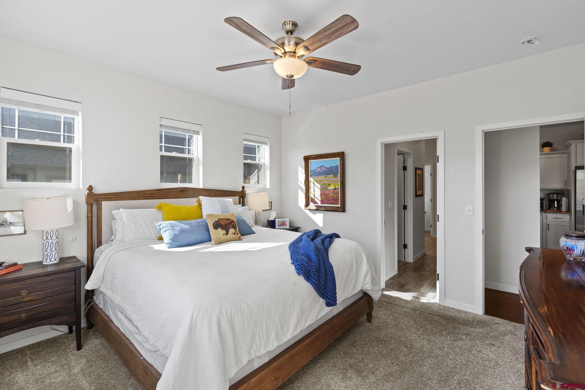 155 Prospector Avenue Durango, CO 81301 - Photo 17 of 35 a bedroom with a bed and a chandelier