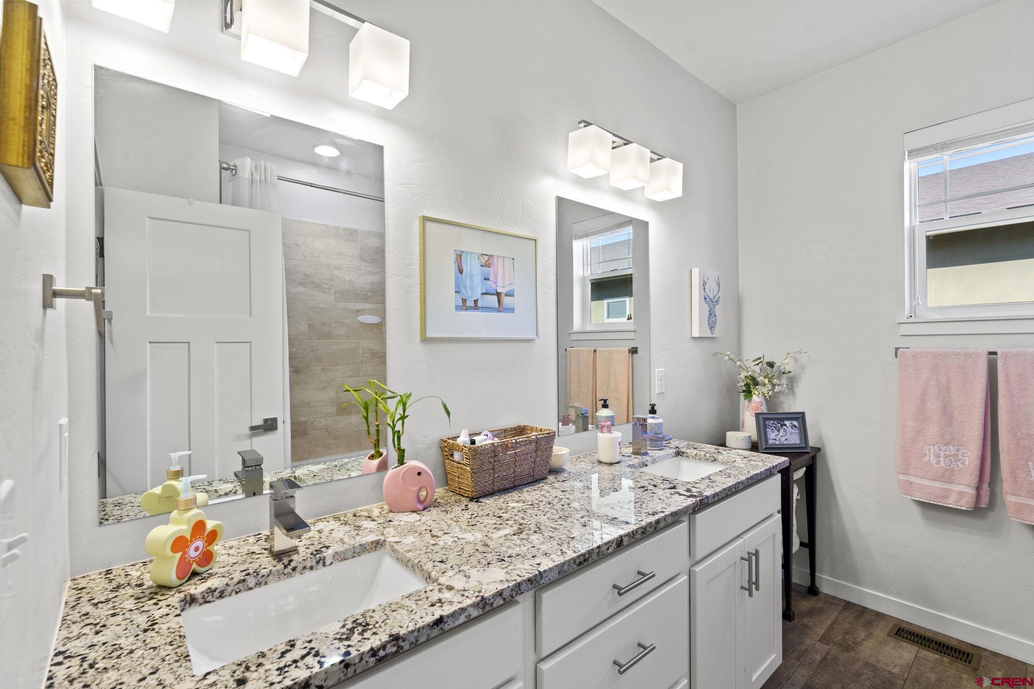 155 Prospector Avenue Durango, CO 81301 - Photo 19 of 35 a bathroom with a granite countertop sink and a mirror