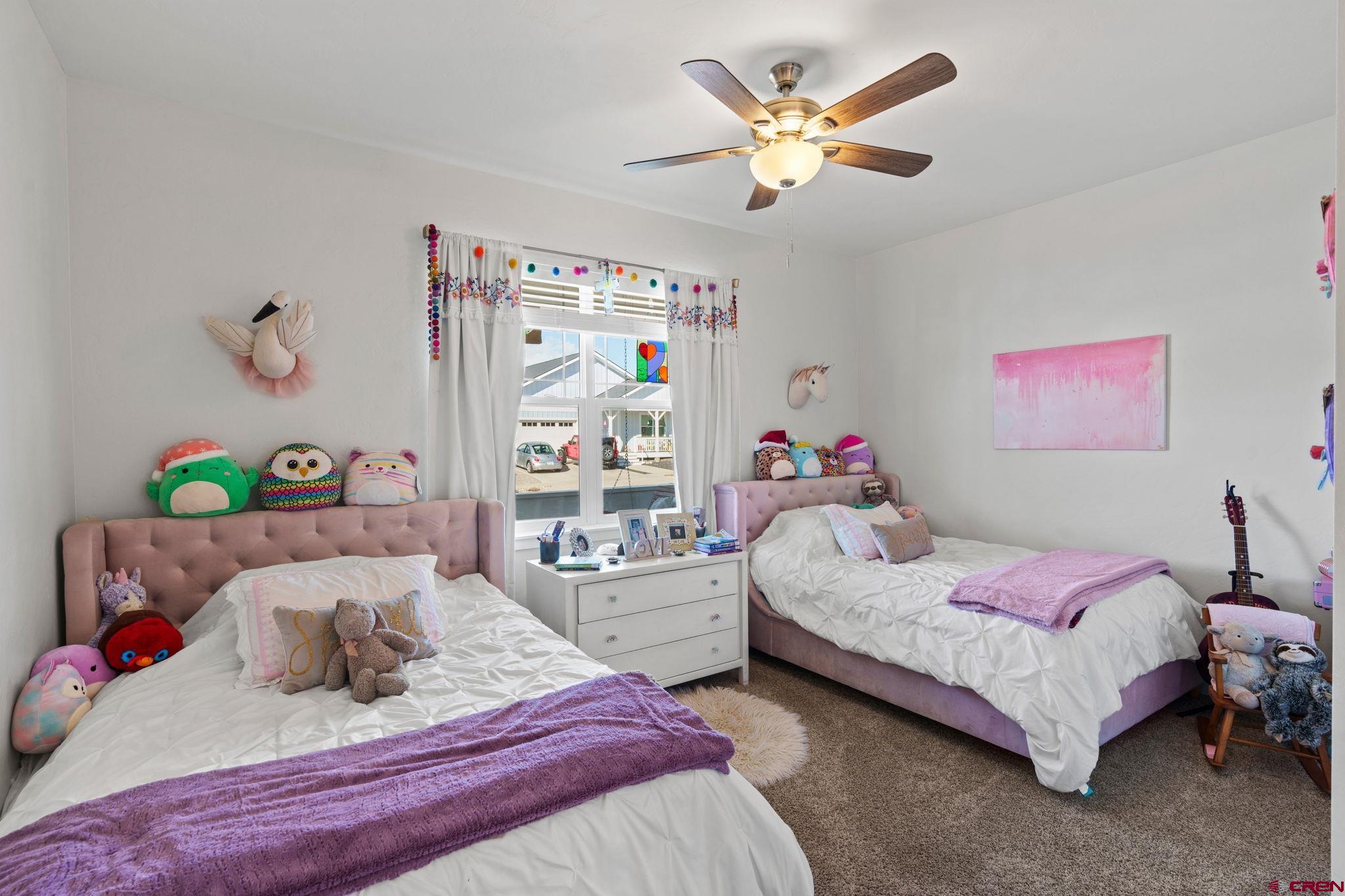 155 Prospector Avenue Durango, CO 81301 - Photo 22 of 35 a bedroom with a bed and a chandelier