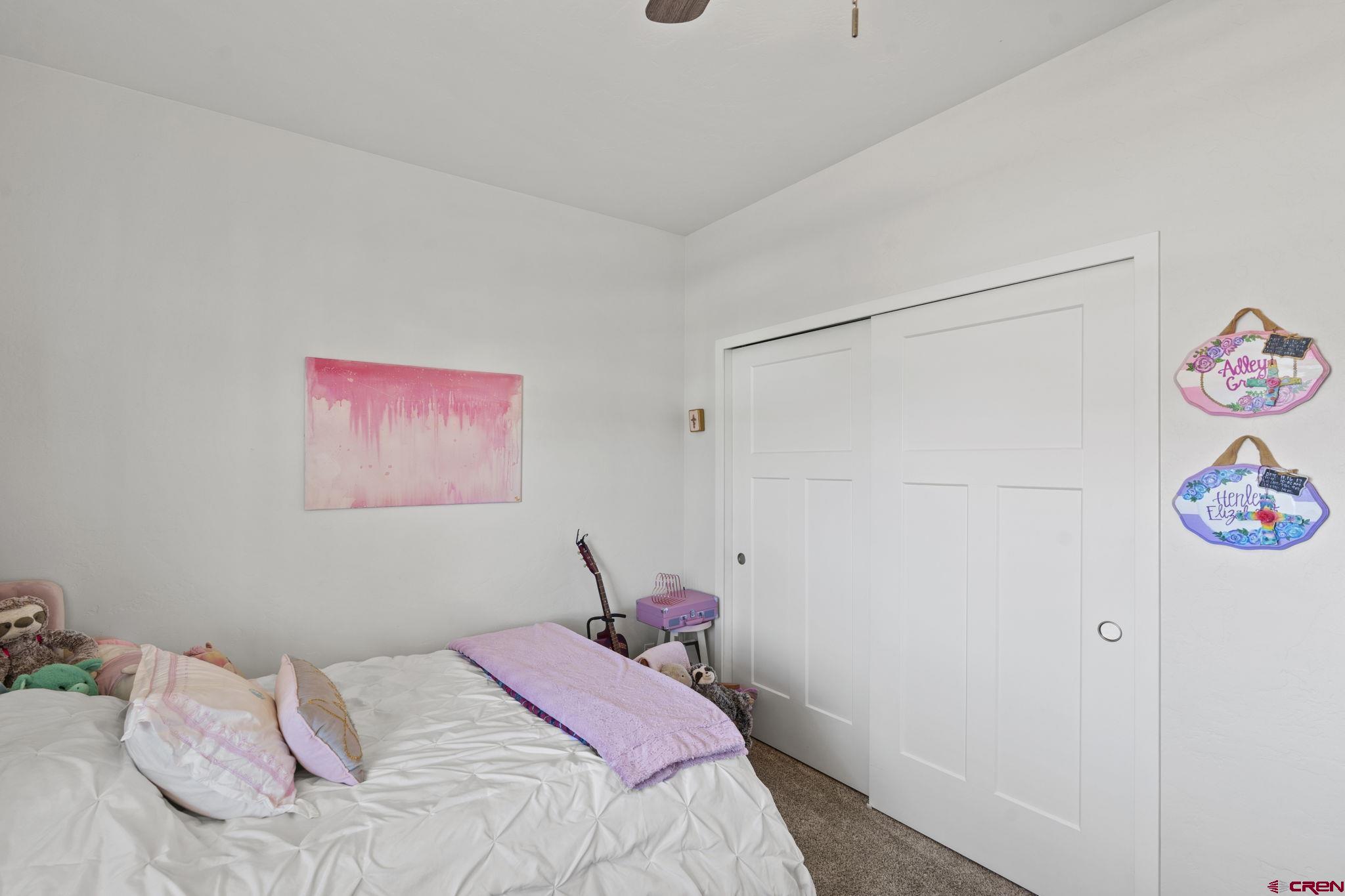 155 Prospector Avenue Durango, CO 81301 - Photo 23 of 35 a bedroom with a bed and a painting on the wall