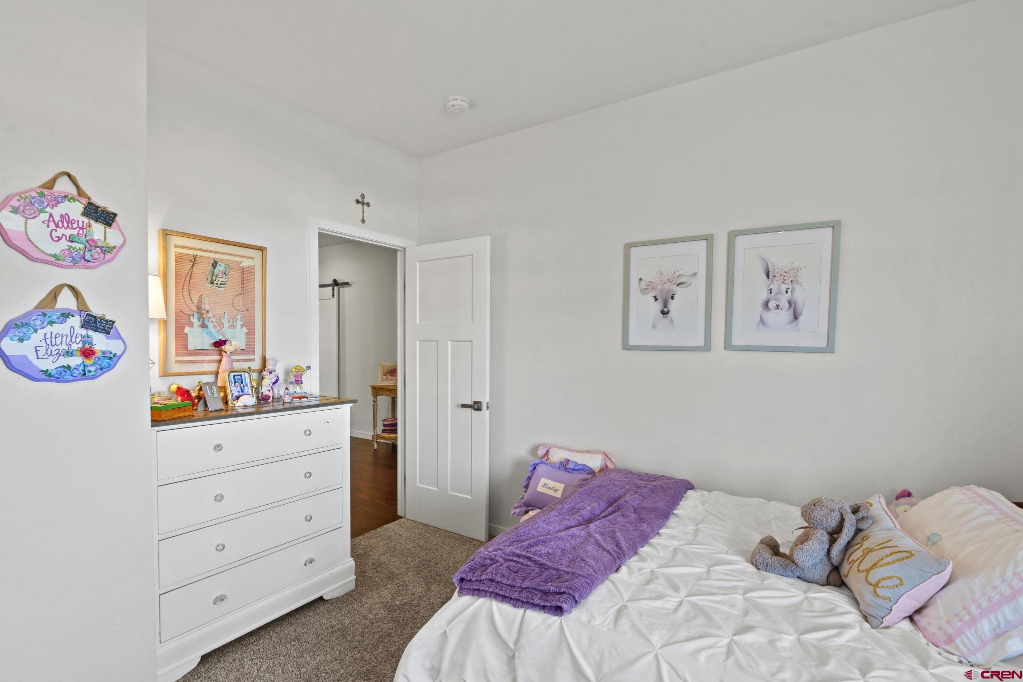 155 Prospector Avenue Durango, CO 81301 - Photo 24 of 35 a bedroom with a bed and painting on the wall