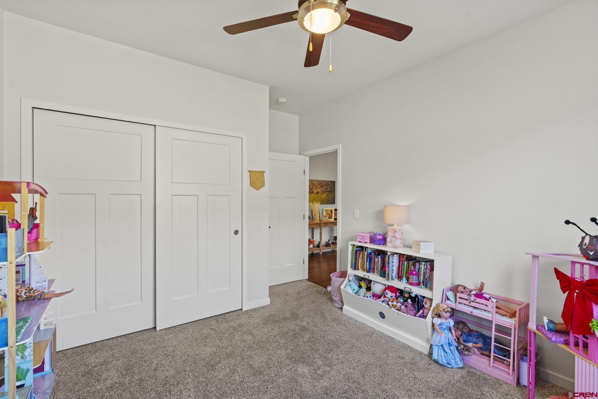 155 Prospector Avenue Durango, CO 81301 - Photo 26 of 35 a living room with furniture and baby crib