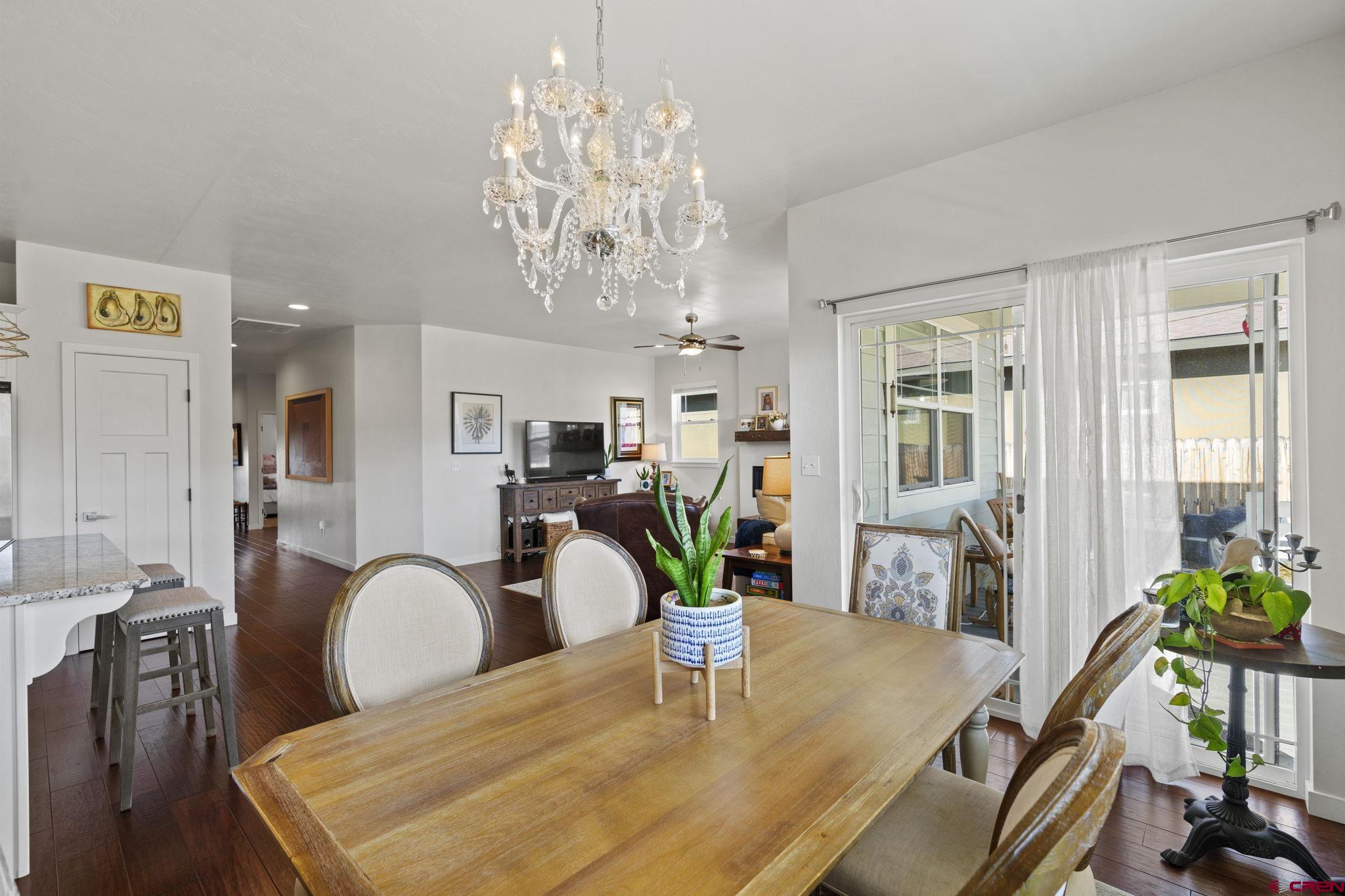 155 Prospector Avenue Durango, CO 81301 - Photo 10 of 35 a view of a dining room with furniture a chandelier and wooden floor
