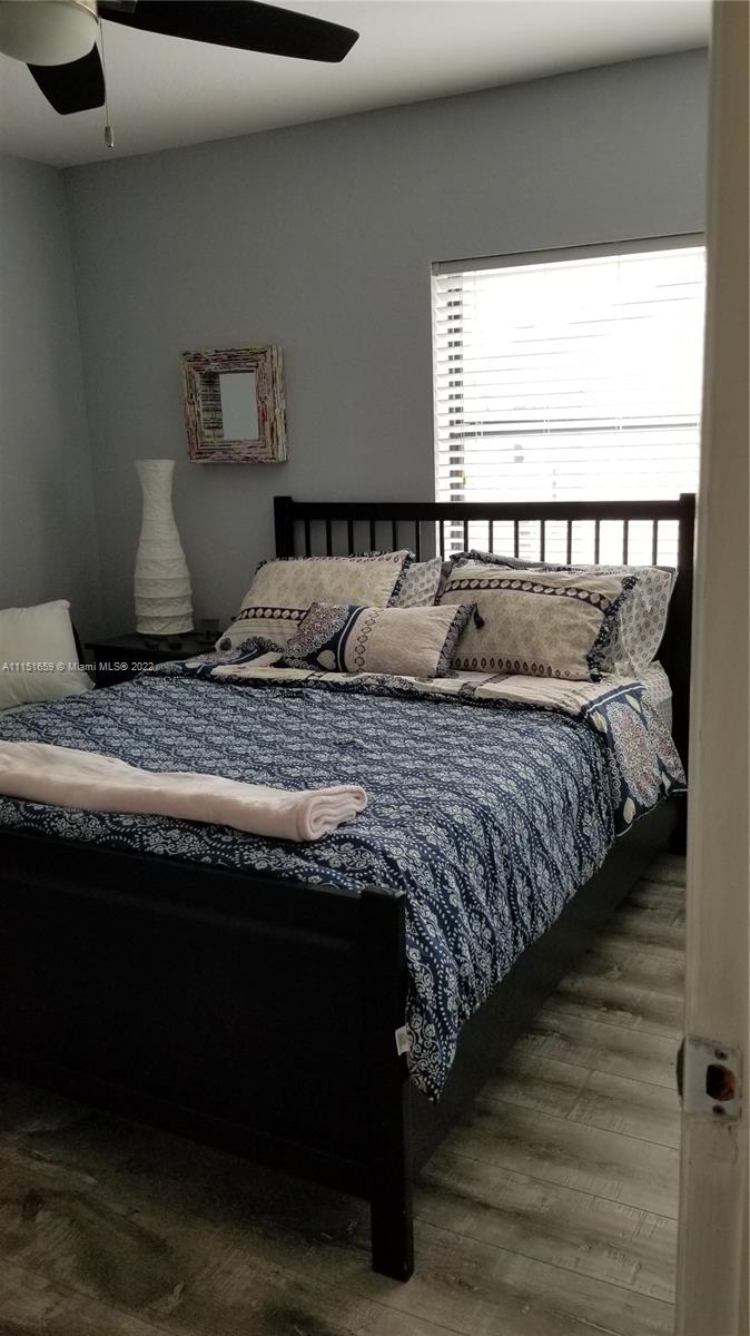 11368 Taft Street, Unit 11368 Pembroke Pines, FL 33026 - Photo 12 of 20 a bed sitting in a bedroom next to a window