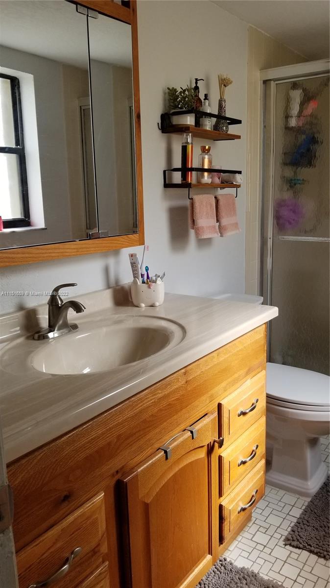 11368 Taft Street, Unit 11368 Pembroke Pines, FL 33026 - Photo 19 of 20 a bathroom with a sink and a mirror