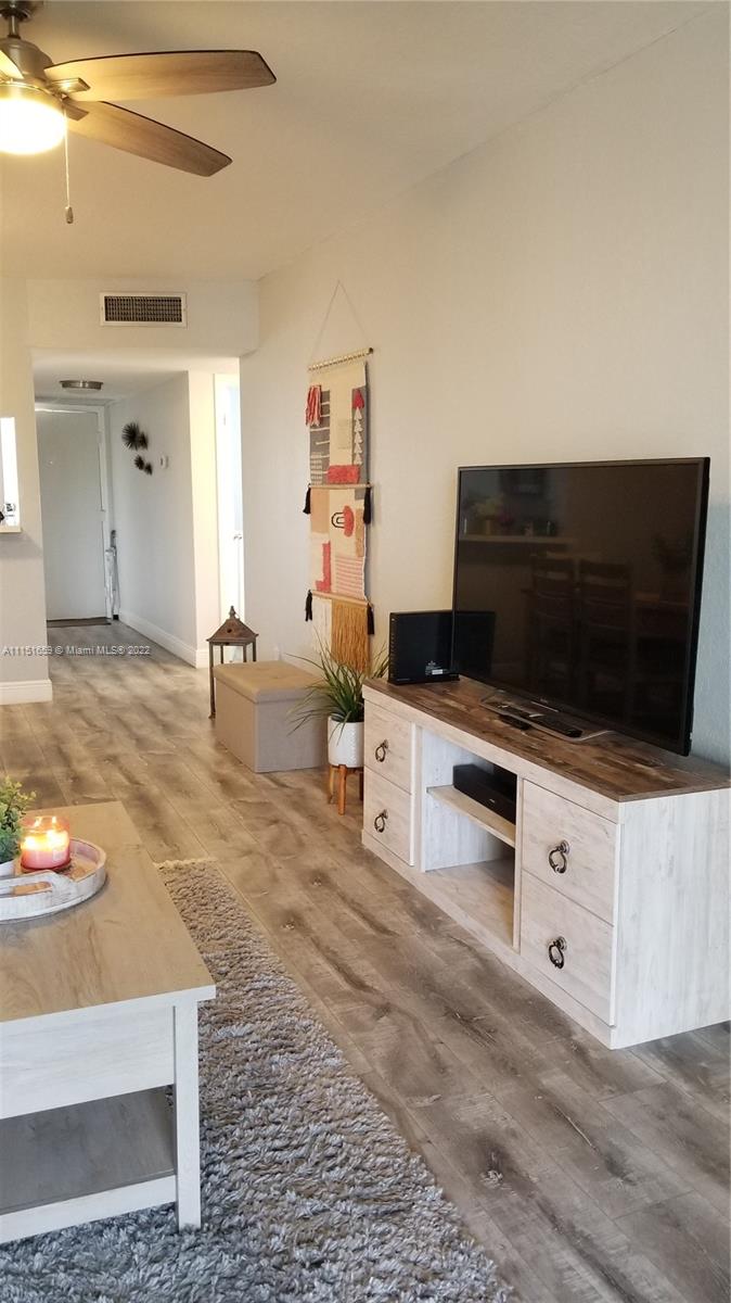 11368 Taft Street, Unit 11368 Pembroke Pines, FL 33026 - Photo 7 of 20 a living room with furniture and a flat screen tv