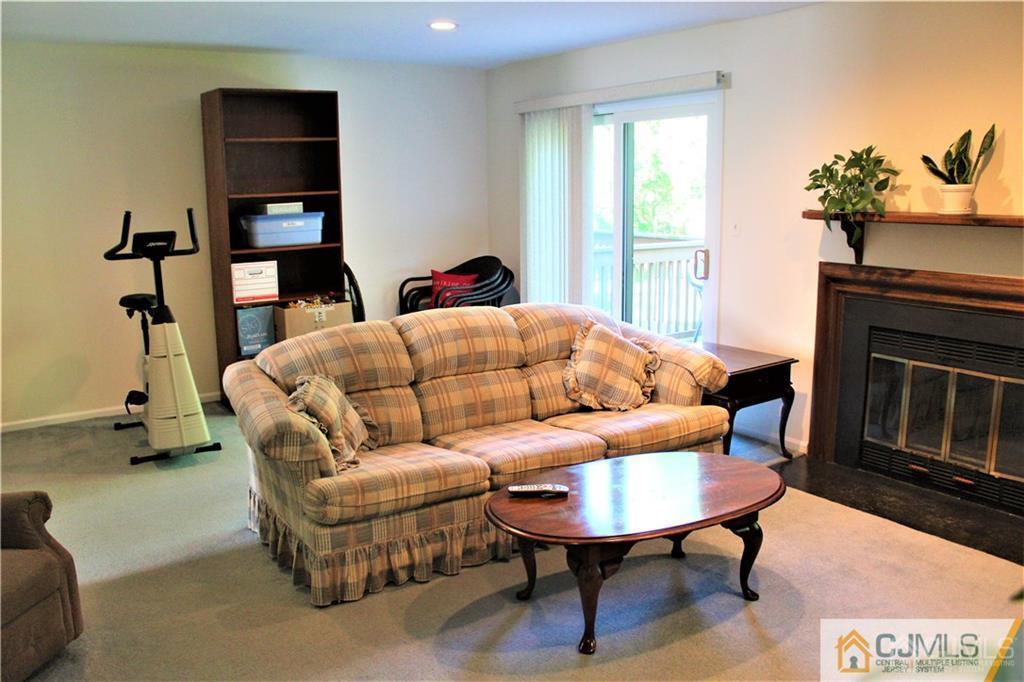 3904 Springbrook Drive, Unit 3904 Edison, NJ 08820 - Photo 12 of 25 a living room with furniture and a fireplace
