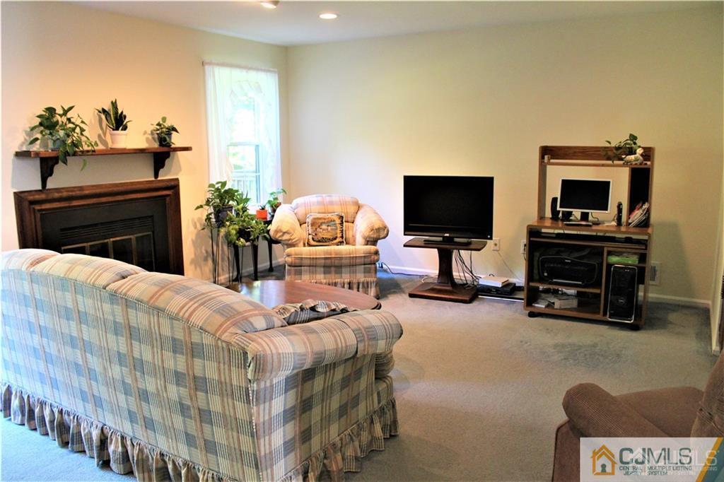 3904 Springbrook Drive, Unit 3904 Edison, NJ 08820 - Photo 13 of 25 a bedroom with furniture and a fireplace