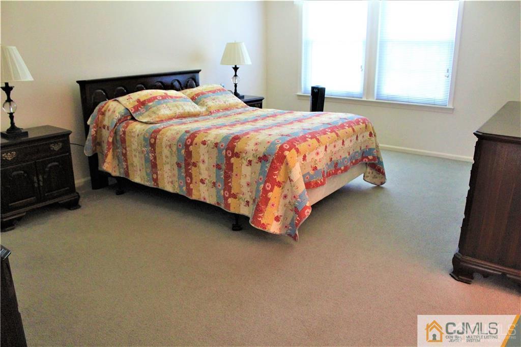 3904 Springbrook Drive, Unit 3904 Edison, NJ 08820 - Photo 16 of 25 a bedroom with a bed and a flat screen tv