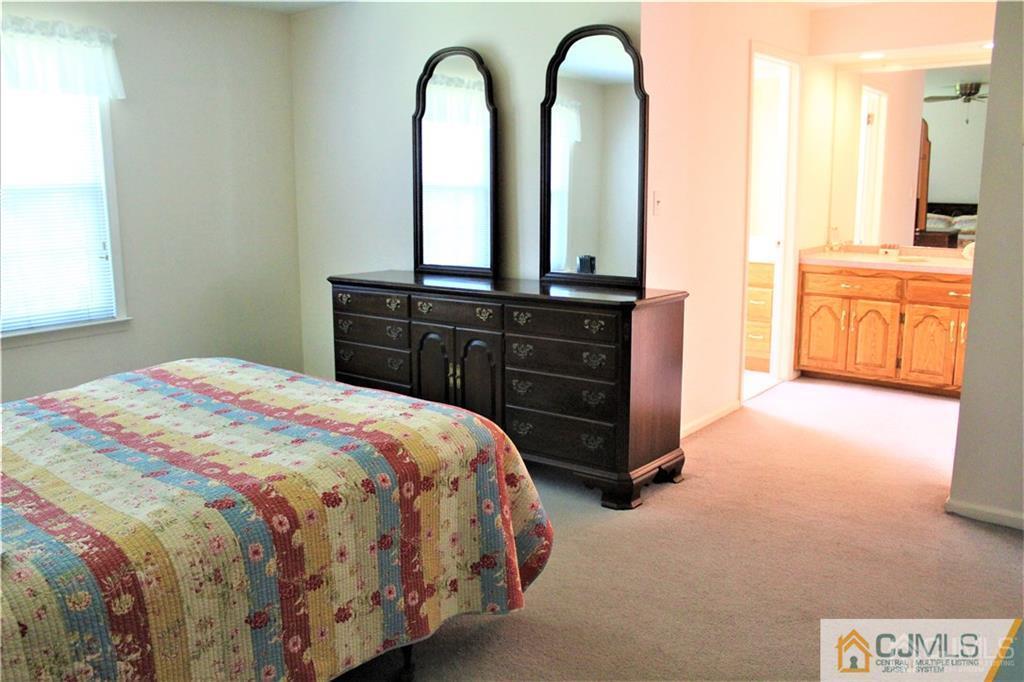 3904 Springbrook Drive, Unit 3904 Edison, NJ 08820 - Photo 17 of 25 a spacious bedroom with a bed and a dresser