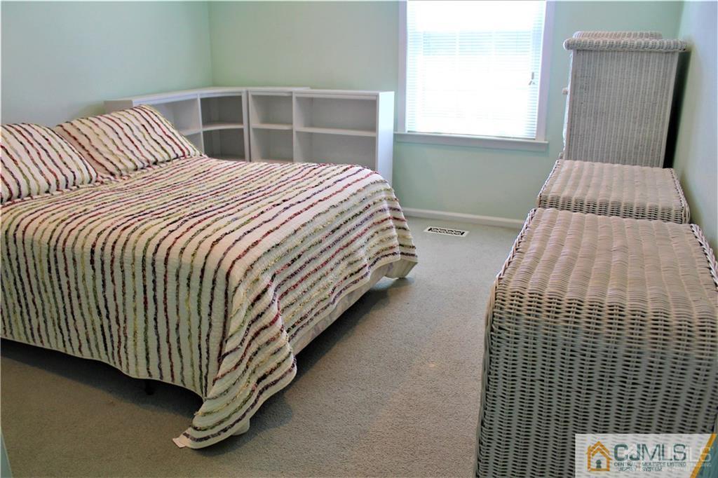 3904 Springbrook Drive, Unit 3904 Edison, NJ 08820 - Photo 20 of 25 a bedroom with bed and window