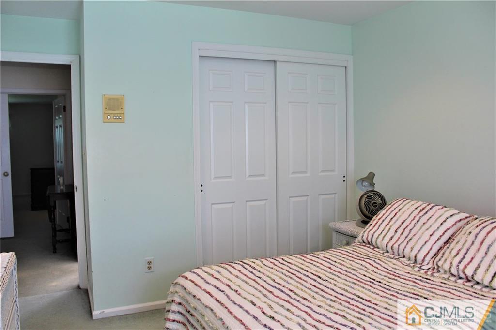 3904 Springbrook Drive, Unit 3904 Edison, NJ 08820 - Photo 21 of 25 a bedroom with a bed and a closet