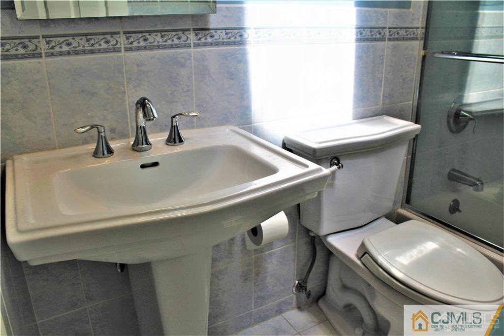 3904 Springbrook Drive, Unit 3904 Edison, NJ 08820 - Photo 22 of 25 a bathroom with a sink toilet and shower