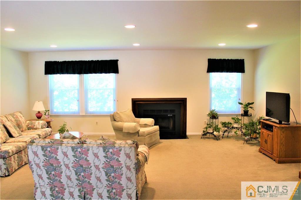 3904 Springbrook Drive, Unit 3904 Edison, NJ 08820 - Photo 3 of 25 a bedroom with a bed and large windows