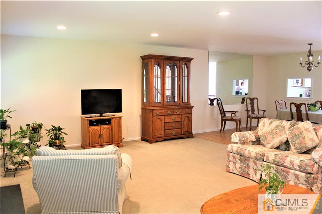 3904 Springbrook Drive, Unit 3904 Edison, NJ 08820 - Photo 4 of 25 a living room with furniture and a flat screen tv