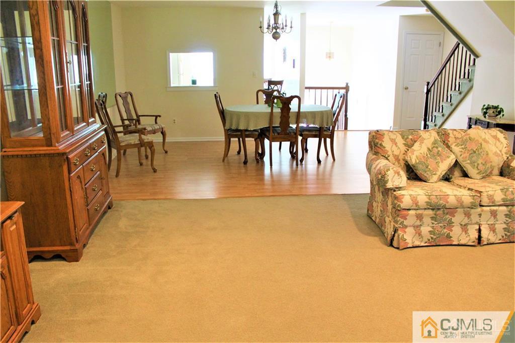 3904 Springbrook Drive, Unit 3904 Edison, NJ 08820 - Photo 6 of 25 a view of a dining room with furniture and a chandelier