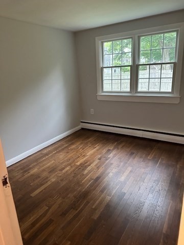 86 Seabrook Road Barnstable, MA 02601 - Photo 8 of 12 an empty room with wooden floor and windows