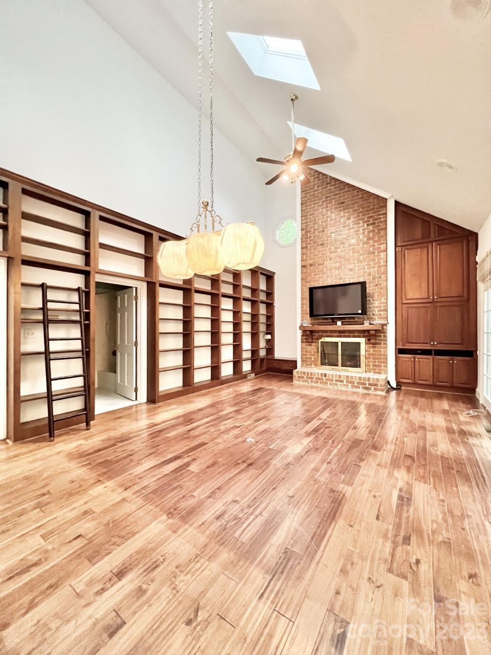 5614 Laurium Road Charlotte, NC 28226 - Photo 14 of 40 a view of empty room with a fireplace and workspace