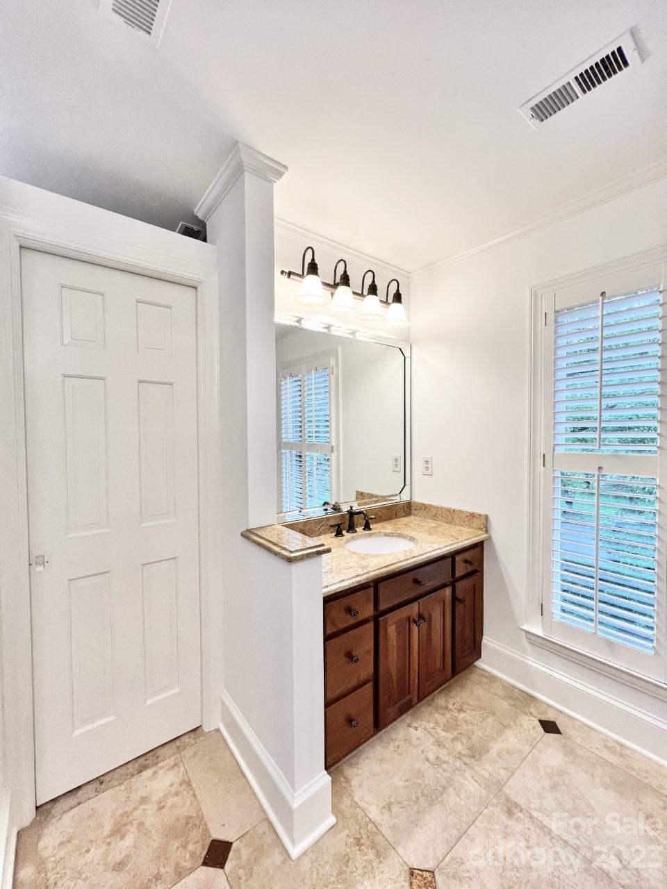 5614 Laurium Road Charlotte, NC 28226 - Photo 24 of 40 a spacious bathroom with a granite countertop sink and a mirror