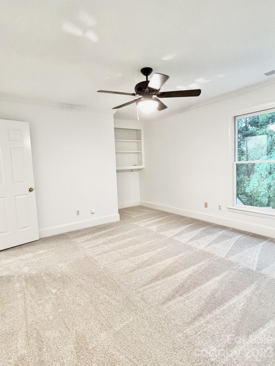 5614 Laurium Road Charlotte, NC 28226 - Photo 36 of 40 a view of a room with a ceiling fan and a window