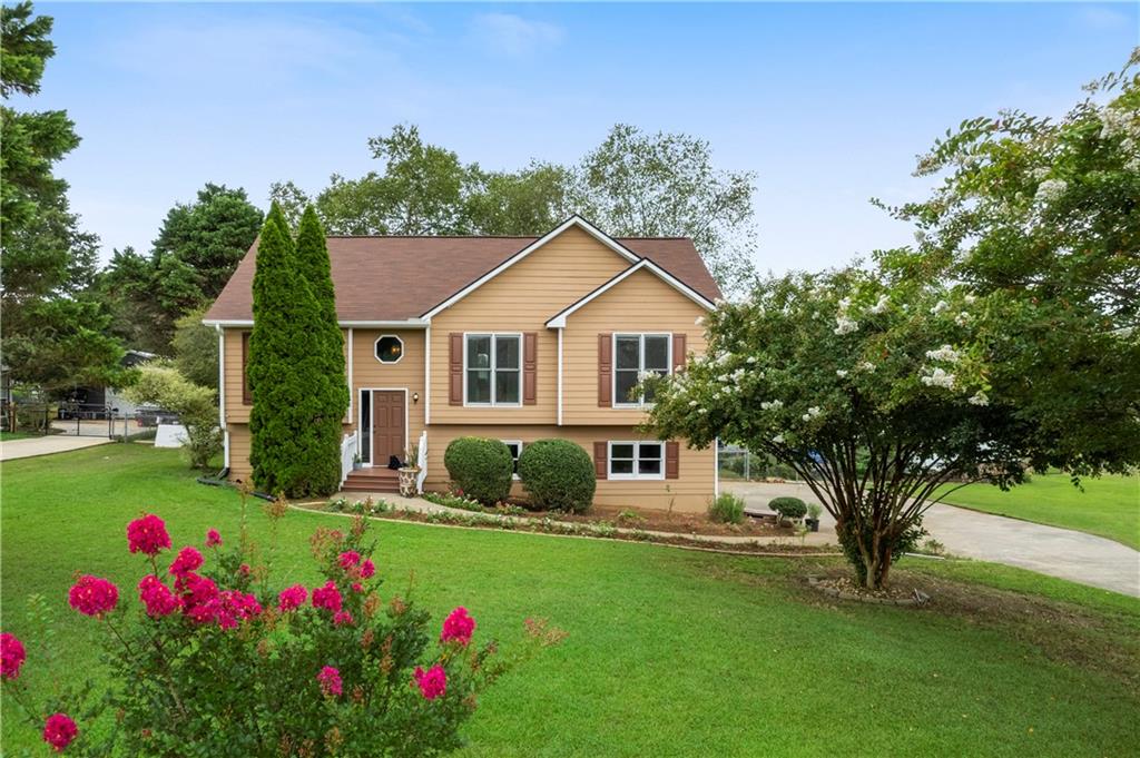 a front view of a house with a yard and garage