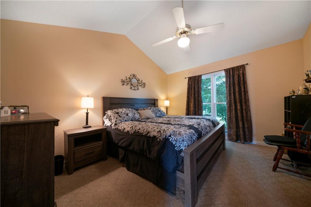 520 Brown Farm Road Southwest Cartersville, GA 30120 - Photo 11 of 16 a bedroom with a bed and a flat tv screen on the dresser