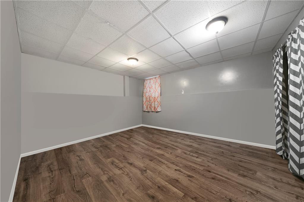 520 Brown Farm Road Southwest Cartersville, GA 30120 - Photo 12 of 16 an empty room with wooden floor and windows