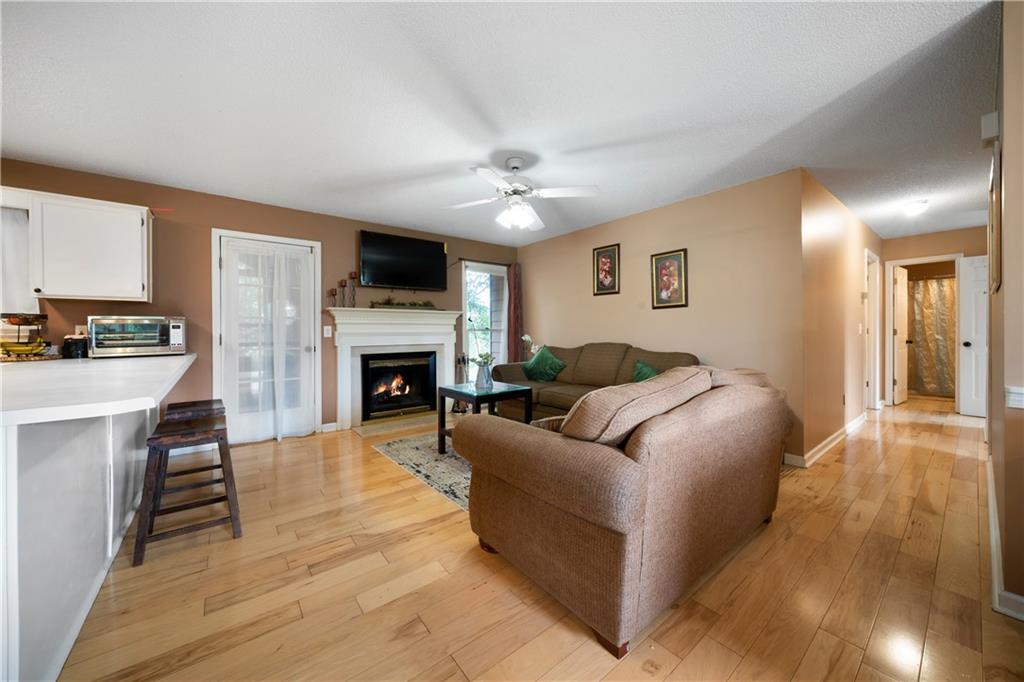 520 Brown Farm Road Southwest Cartersville, GA 30120 - Photo 4 of 16 a living room with furniture a flat screen tv and a fireplace