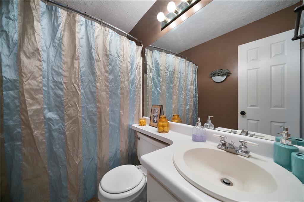 520 Brown Farm Road Southwest Cartersville, GA 30120 - Photo 10 of 16 a bathroom with a sink a toilet and shower curtain