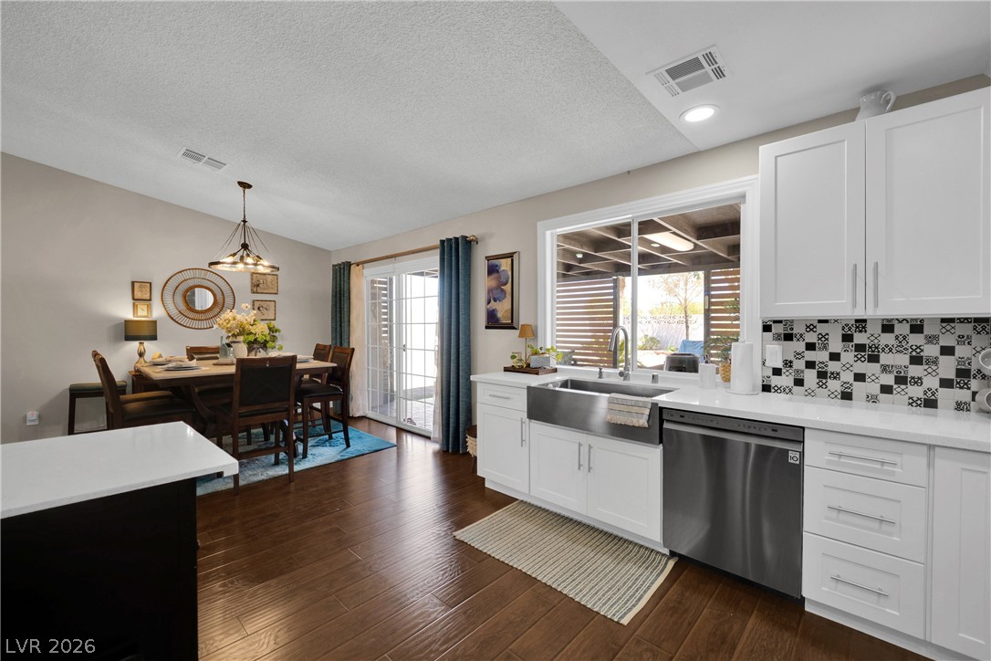 530 Grape Drive Henderson, NV 89015 - Photo 9 of 39 Hardwood floors stretch across this open-concept kitchen and dining area, leading to a charming patio.
